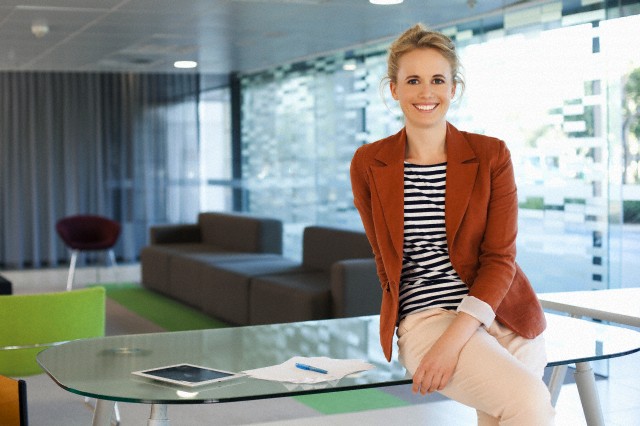 Businesswoman sitting on desk